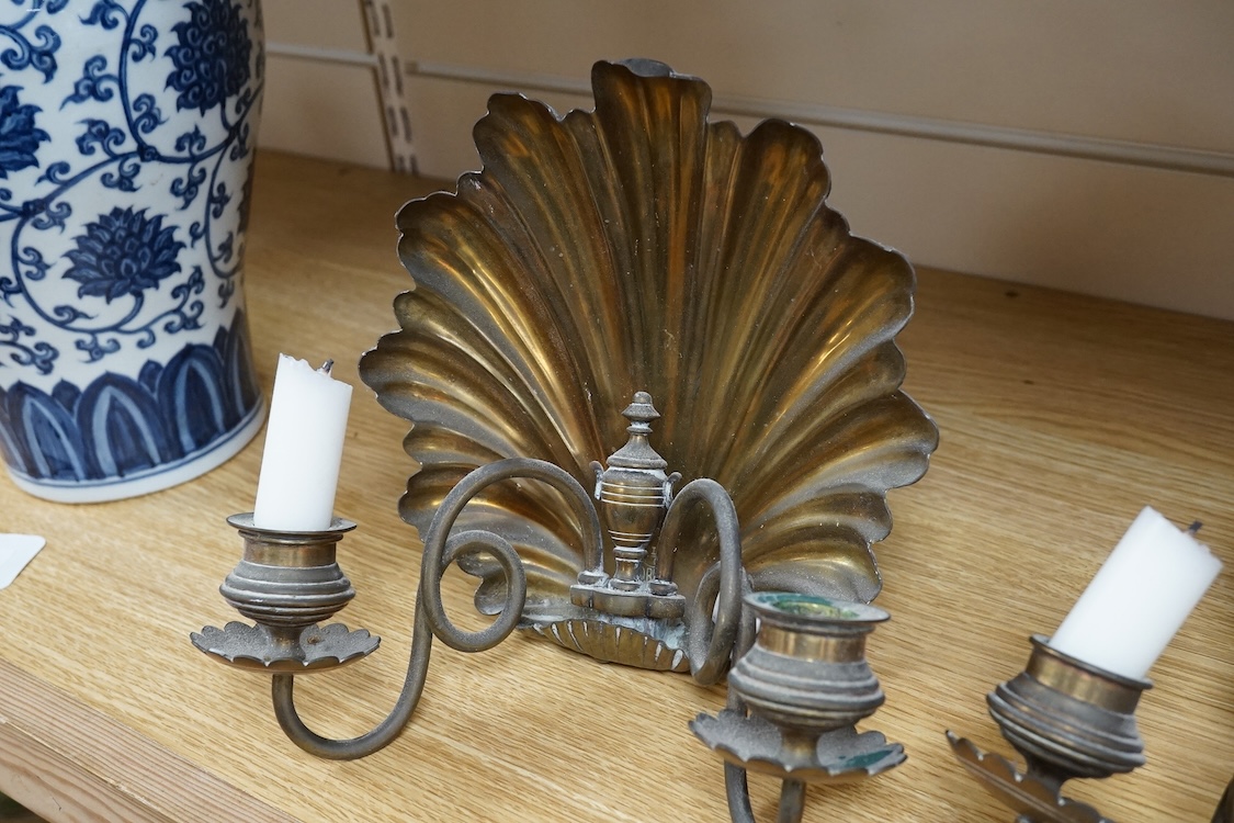 A pair of brass twin branch wall lights with scallop shell backs, 26cm high